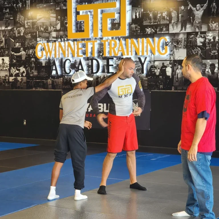 Photo of instructors demonstrating a self-defense move.